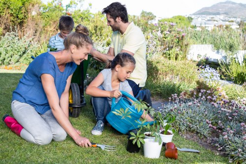 Gardener inspecting a landscaped front yard before work
